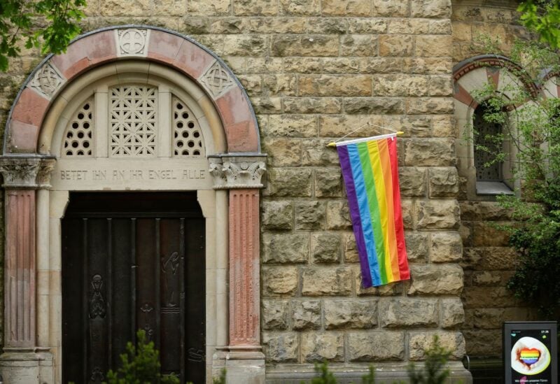 A rainbow flag is seen on the wall of a Catholic church as the building is open for same-sex couples to receive a blessing in Cologne, Germany, May 10, 2021. REUTERS/Thilo Schmuelgen
