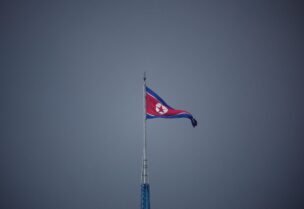 A North Korean flag flutters at the propaganda village of Gijungdong in North Korea, in this picture taken near the truce village of Panmunjom inside the demilitarized zone (DMZ) separating the two Koreas, South Korea, July 19, 2022. REUTERS/Kim Hong-Ji/Pool