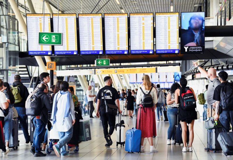 People walk at Schiphol Airport in Amsterdam, Netherlands June 16, 2022. REUTERS/Piroschka van de Wouw