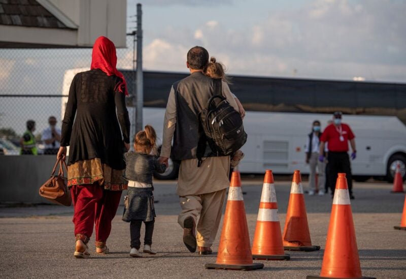Afghan refugees who supported Canada's mission in Afghanistan prepare to board buses after arriving in Canada, at Toronto Pearson International Airport August 24, 2021. Picture taken August 24, 2021. MCpl Genevieve Lapointe/ Canadian Forces Combat Camera/Canadian Armed Forces Photo/Handout via REUTERS