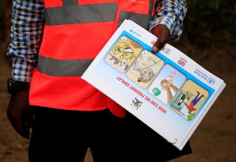 An Ugandan health worker shows an informational flyer on Ebola virus and how to prevent its spread to the community of Kirembo village, near the border with the Democratic Republic of Congo, in Kasese district, Uganda June 15, 2019. REUTERS/James Akena/Files