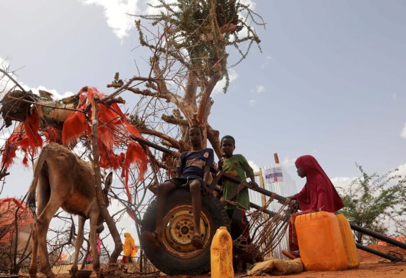 Internally displaced children pose for a photo next to a donkey-cart outside their makeshift shelters at the Kaxareey camp for the internally displaced people in Dollow, Gedo region of Somalia May 24, 2022. Picture taken May 24, 2022. REUTERS/Feisal Omar/File Photo