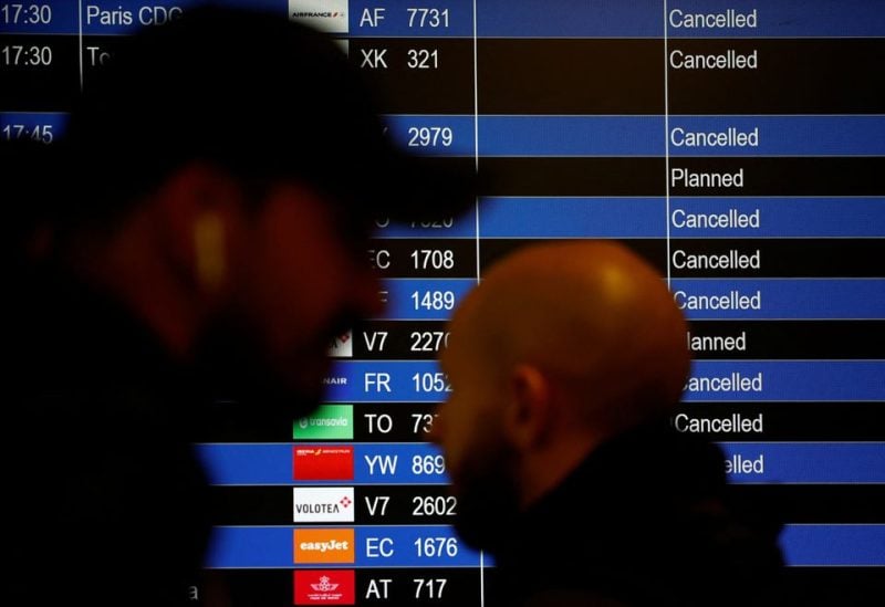 Travellers walk past a flight departure screen displaying a series of flight cancellations during an air traffic controller's strike at the Nantes Atlantique airport in Bouguenais near Nantes, France, September 16, 2022. REUTERS/Stephane Mahe