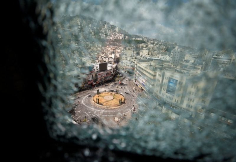 A roundabout is seen through a damaged window following clashes between Palestinian security forces and gunmen over the arrest of two Palestinian militants, in Nablus in the Israeli-occupied West Bank September 20, 2022. REUTERS/Mohamad Torokman