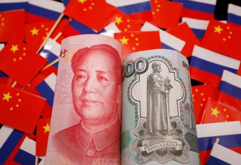 Banknotes of Chinese yuan and Russian rouble are seen amid flags of China and Russia in this illustration picture taken September 15, 2022. REUTERS/Florence Lo/Illustration