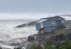 Waves roll in near a damaged house built close to the shore as Hurricane Fiona, later downgraded to a post-tropical cyclone, passes the Atlantic settlement of Port aux Basques, Newfoundland and Labrador, Canada September 24, 2022. Courtesy of Wreckhouse Press/Handout via REUTERS