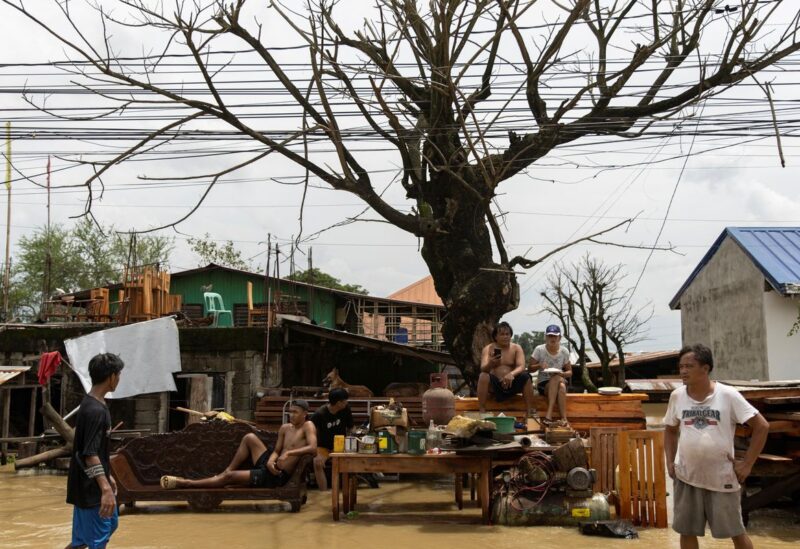 Residents who evacuated from their flooded homes sit on a roadside after Super Typhoon Noru, in San Ildefonso, Bulacan province, Philippines, September 26, 2022. REUTERS/Eloisa Lopez