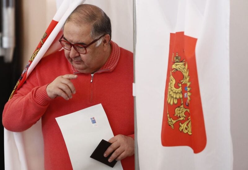 Russian billionaire Alisher Usmanov walks out of a voting booth at a polling station during the presidential election in Moscow, Russia March 18, 2018. REUTERS/Maxim Shemetov