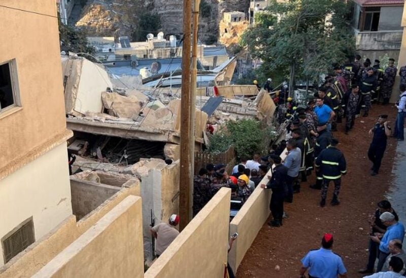 Civil defense members work at the site of a four-storey residential building collapse in Amman, Jordan September 13, 2022. (Reuters)