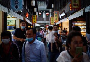 People wearing face masks walk on Jinli Ancient Street, following the coronavirus disease (COVID-19) outbreak, in Chengdu, Sichuan province, China