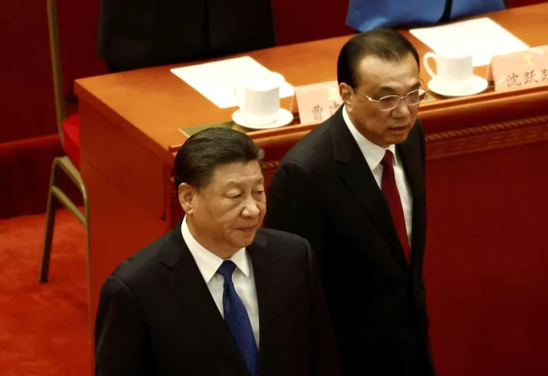 Chinese President Xi Jinping and Premier Li Keqiang arrive for the closing session of the Chinese People's Political Consultative Conference (CPPCC) at the Great Hall of the People in Beijing, China March 10, 2022. REUTERS