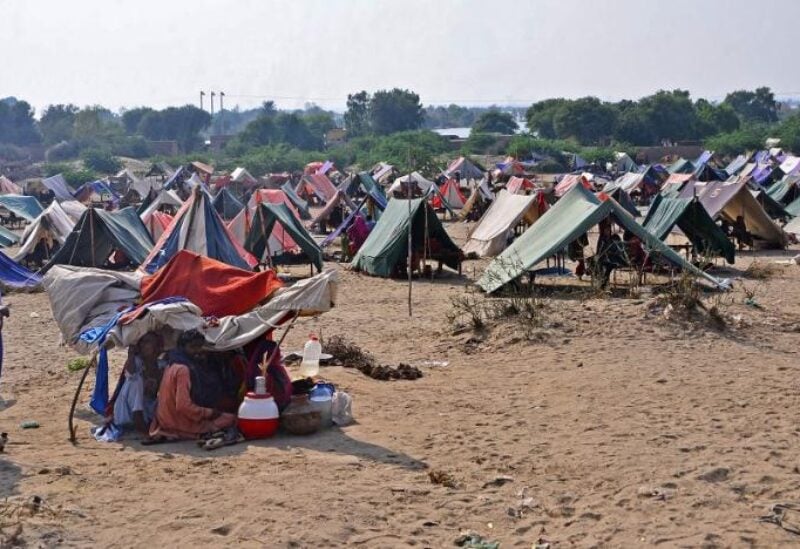 Internally displaced flood-affected people take refuge at a makeshift camp in Dadu district of Sindh province on September 14, 2022.