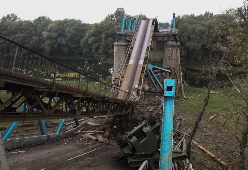 A military vehicle is seen near a destroyed bridge over the Siverskyi Donets river in the town of Izium recently liberated by the Ukrainian Armed Forces during a counteroffensive operation, amid Russia's attack on Ukraine, in Kharkiv region, Ukraine September 15, 2022. REUTERS/Vyacheslav Madiyevskyy