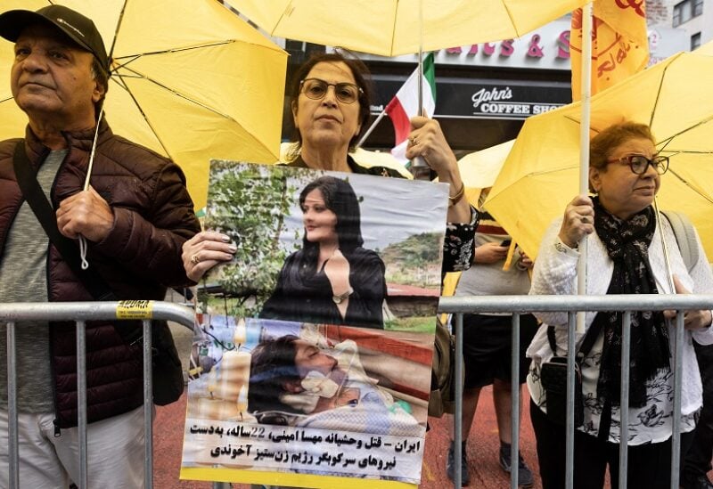 A demonstrator holds a picture of Mahsa Amini, who died in police custody in Iran, in New York City, New York, U.S., September 22, 2022. REUTERS/Caitlin Ochs