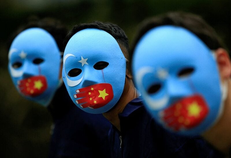 FILE PHOTO: Activists take part in a protest against China's treatment towards the ethnic Uyghur people and calling for a boycott of the 2022 Winter Olympics in Beijing, at a park Jakarta, Indonesia, January 4, 2022. REUTERS/Willy Kurniawan/File Photo