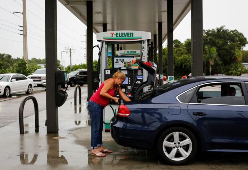 A woman fills up a container with gasoline at a gas station as Hurricane Ian spins toward the state carrying high winds, torrential rains and a powerful storm surge, in Port Charlotte, Florida, U.S. September 27, 2022. REUTERS