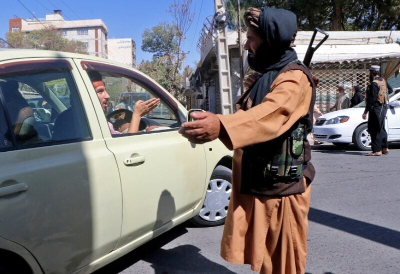 Taliban fighters stop motorists on a road after a blast outside a mosque in Herat in western Afghanistan, September 2, 2022. REUTERS/Stringer NO RESALES. NO ARCHIVES.
