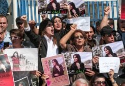Women chant slogans and hold up signs depicting the image of 22-year-old Mahsa Amini, who died while in the custody of Iranian authorities, during a demonstration denouncing her death by Iraqi and Iranian Kurds outside the UN offices in Erbil, the capital of Iraq's autonomous Kurdistan region, on September 24, 2022. (AFP)