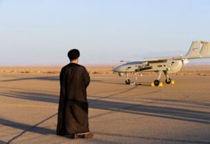 An Iranian cleric stands near a drone during a military exercise in an undisclosed location in Iran, in this handout image obtained on August 24, 2022. Iranian Army/WANA (West Asia News Agency)/Handout via REUTERS ATTENTION EDITORS - THIS IMAGE HAS BEEN SUPPLIED BY A THIRD PARTY.