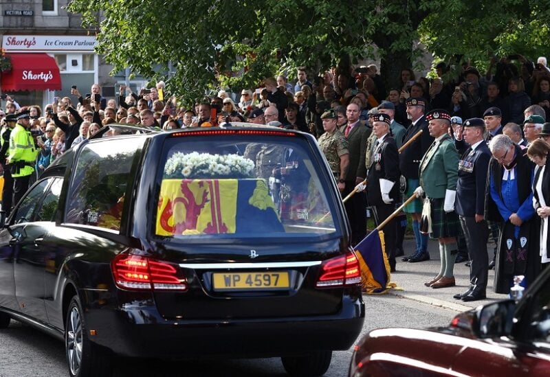 The hearse carrying the coffin of Britain's Queen Elizabeth passes through the village of Ballater, near Balmoral, Scotland, Britain, September 11, 2022. REUTERS/Hannah McKay