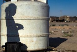 The shadow of a Syrian girl is cast upon a water container at the Sahlah al-Banat camp for displaced people in the countryside of Raqa, in northern Syria, on September 19, 2022.