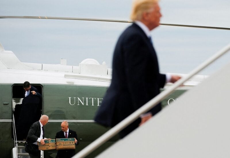 White House aides, including Keith Schiller, carry file boxes aboard as U.S. President Donald Trump boards Air Force One for travel to New York from Joint Base Andrews, Maryland, U.S. May 4, 2017. According to a report published in the New York Times, the boxes Trump would travel with contained documents including "unanswered letters, unread briefing books and unread newspapers." REUTERS/Jonathan Ernst