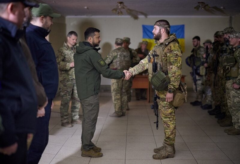 Ukraine's President Volodymyr Zelenskiy awards a Ukrainian service member, amid Russia's attack on Ukraine, near a frontline in Kharkiv region, Ukraine September 14, 2022. Ukrainian Presidential Press Service/Handout via REUTERS ATTENTION EDITORS - THIS IMAGE HAS BEEN SUPPLIED BY A THIRD PARTY.