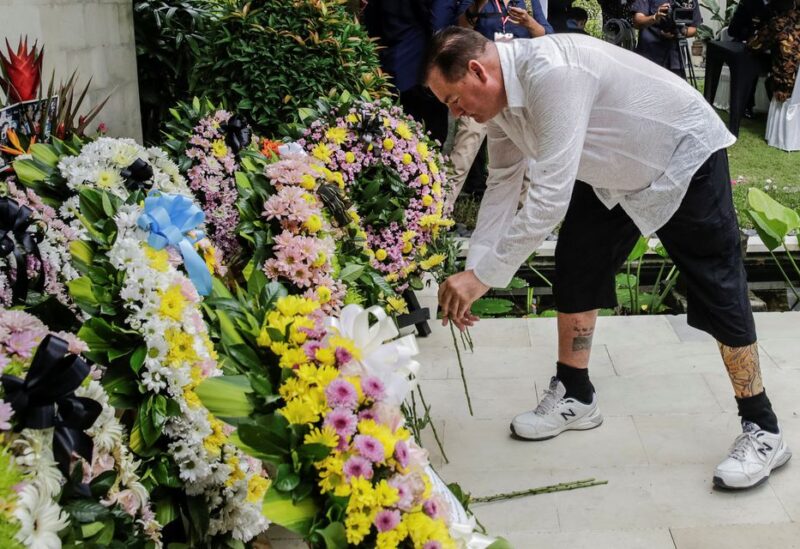 Australian Bali bombing survivor, Andrew Csabi lays a flower during the commemoration of the 20th anniversary of the Bali bombing that killed 202 people, mostly foreign tourists, including 88 Australians and seven Americans, at the Australian Consulate in Denpasar, Bali, Indonesia, October 12, 2022. Johannes P. Christo/Pool via REUTERS