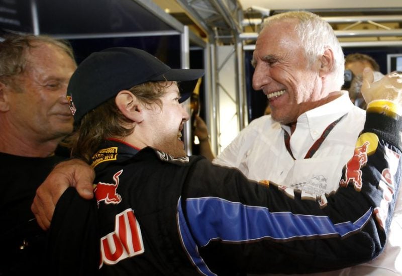 Red Bull owner Dietrich Mateschitz (R) congratulates Red Bull Formula One driver Sebastian Vettel of Germany for winning the championship and the Abu Dhabi Grand Prix at the Yas Marina circuit November 14, 2010. REUTERS/Ahmed Jadallah