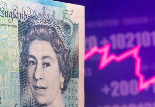 A British Pound banknote is seen in front of displayed stock graph in this illustration taken May 7, 2021. REUTERS/Dado Ruvic/Illustration