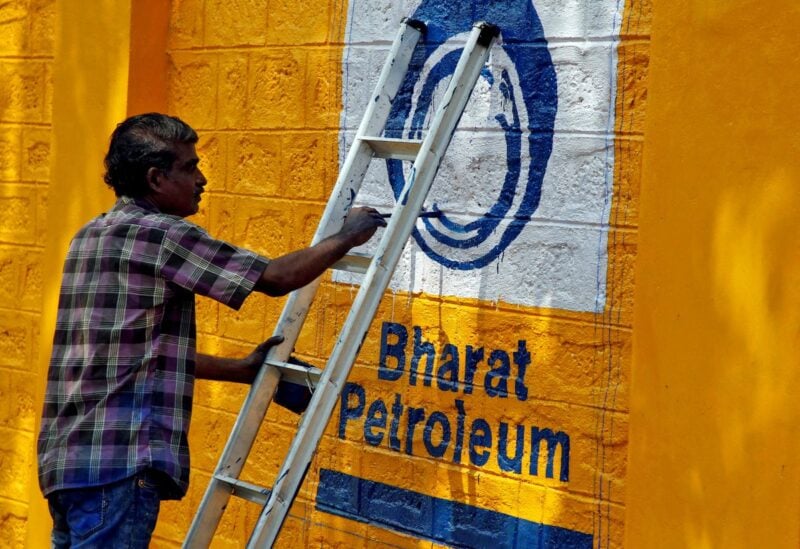 A man paints the logo of oil refiner Bharat Petroleum Corp (BPCL) on a wall on the outskirts of Kochi, India, November 21, 2019. REUTERS/Sivaram V//File Photo