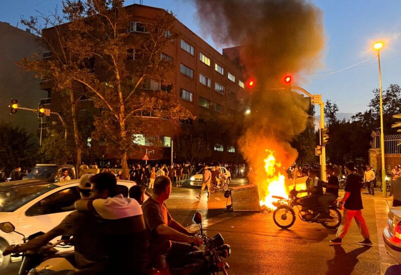 A police motorcycle burns during a protest over the death of Mahsa Amini, a woman who died after being arrested by the Islamic republic's "morality police", in Tehran, Iran September 19, 2022. WANA (West Asia News Agency) via REUTERS//File Photo