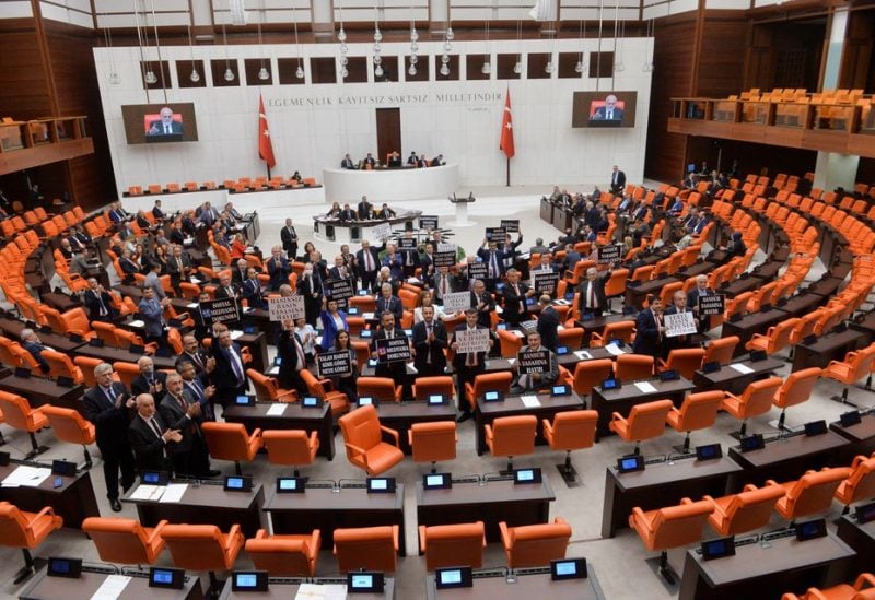 Main opposition Republican People's Party (CHP) lawmakers hold placards as they protest against a contentious media bill, proposed by President Tayyip Erdogan's AK Party and its nationalist allies, at the Turkish Parliament in Ankara, Turkey October 4, 2022. REUTERS/Stringer