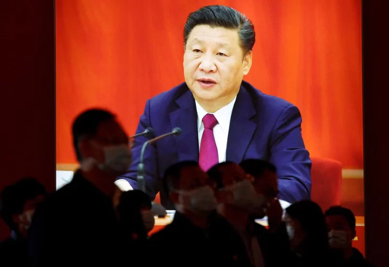 Visitors stand in front of an image of Chinese President Xi Jinping, at an exhibition titled "Forging Ahead in the New Era" during an organised media tour ahead of the 20th National Congress of the Communist Party of China, in Beijing, China October 12, 2022. REUTERS/Florence Lo