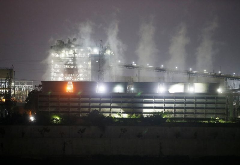 Smoke billows from the cooling towers of a coal-fired power plant in Ahmedabad, India, October 13, 2021. REUTERS/Amit Dave/File Photo