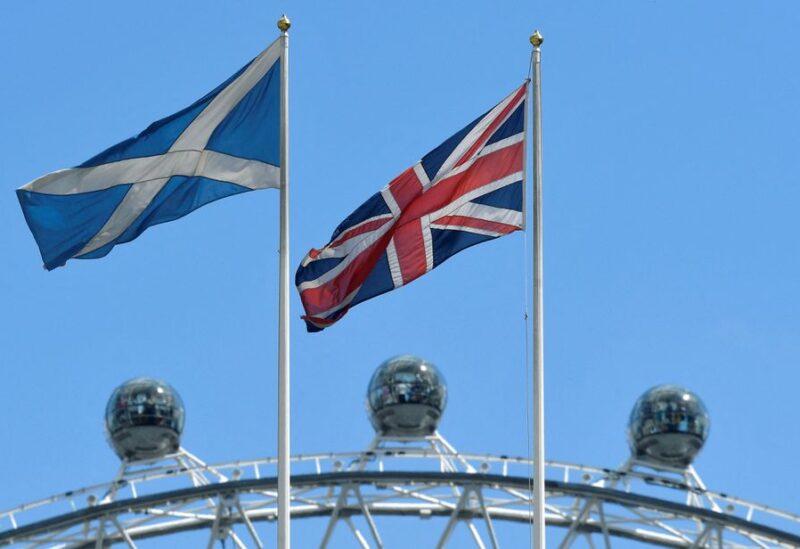 The Scottish Saltire flag flies next to the British Union Jack flag with the London Eye wheel seen behind in London, Britain July 29, 2019. REUTERS/Toby Melville/File Photo