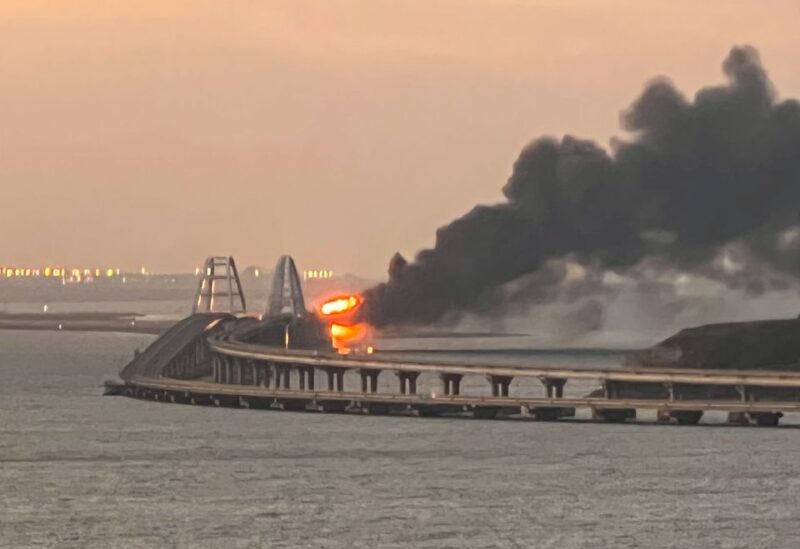 A view shows a fire on the Kerch bridge at sunrise in the Kerch Strait, Crimea, October 8, 2022. REUTERS/Stringer