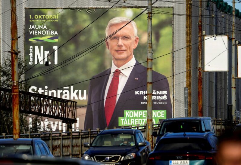 Motorists drive past a giant election campaign poster depicting Latvian Prime Minister Krisjanis Karins of New Unity party in Riga, Latvia September 28, 2022. REUTERS/Ints Kalnins