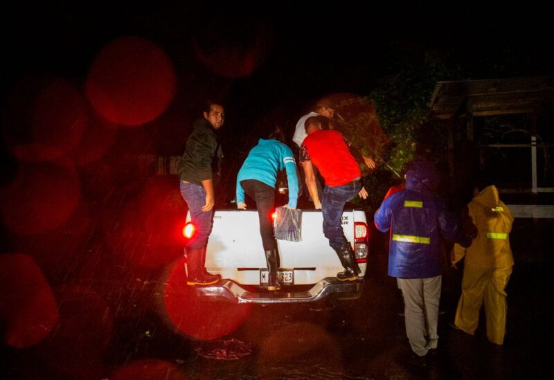 People get into a pickup truck to be transported to a safe zone while Hurricane Julia hits the coasts with wind and rain, in Bluefields, Nicaragua October 8, 2022. REUTERS/Maynor Valenzuela