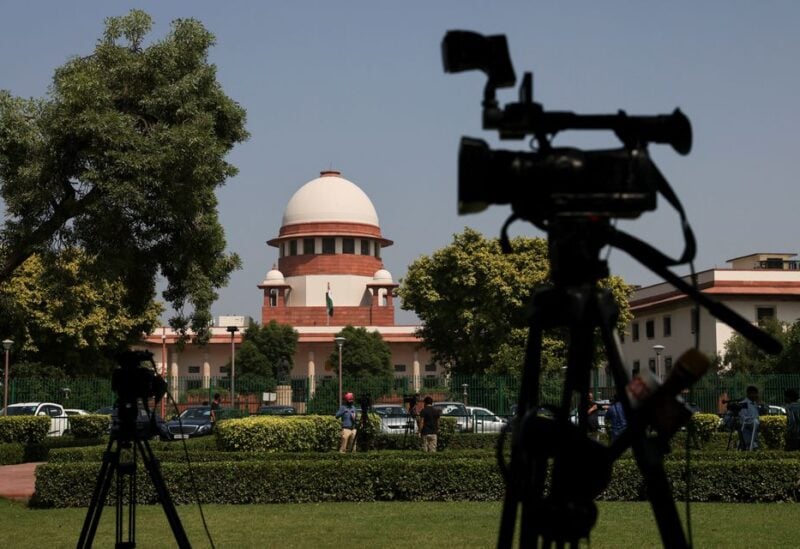Members of media speak in front of cameras after a panel of the Supreme Court said it was divided on a decision to allow hijabs in classrooms, outside the premises of the court in New Delhi, India October 13, 2022. REUTERS/Anushree Fadnavis