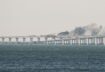 A view shows fuel tanks ablaze and damaged sections of the Kerch bridge in the Kerch Strait, Crimea, October 8, 2022. REUTERS