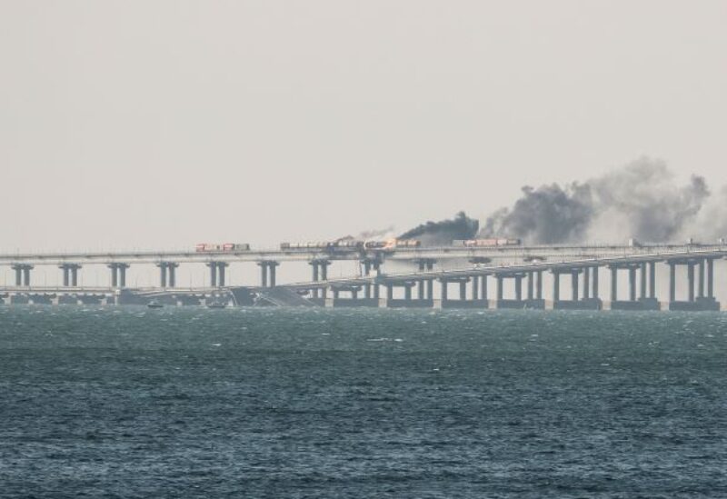 A view shows fuel tanks ablaze and damaged sections of the Kerch bridge in the Kerch Strait, Crimea, October 8, 2022. REUTERS