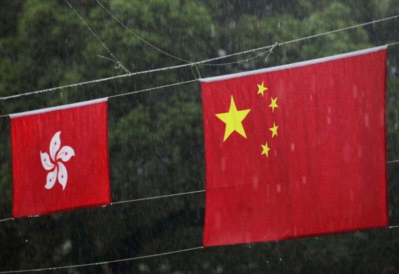 Chinese and Hong Kong flags, decorating a street, hang in the rain, before the 25th anniversary of the former British colony's handover to Chinese rule, in Hong Kong, China June 30, 2022. REUTERS/Paul Yeung