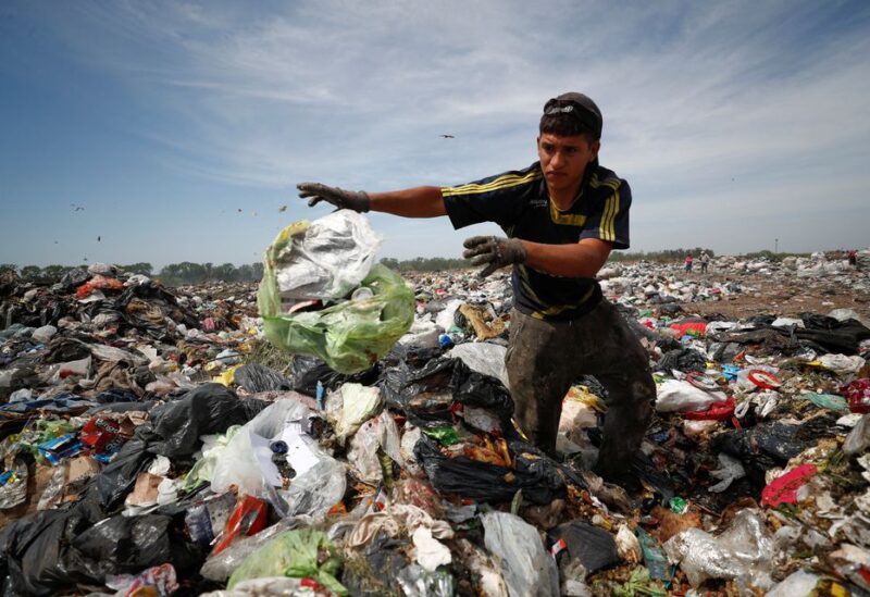 Diego, 19, looks through heaps of waste at a landfill for cardboard, plastic and metal, which he sells while working 12-hour shifts, as Argentina faces one of the world's highest inflation rates, set to top 100% this year, in Lujan, on the outskirts of Buenos Aires, Argentina October 5, 2022. REUTERS/Agustin Marcarian