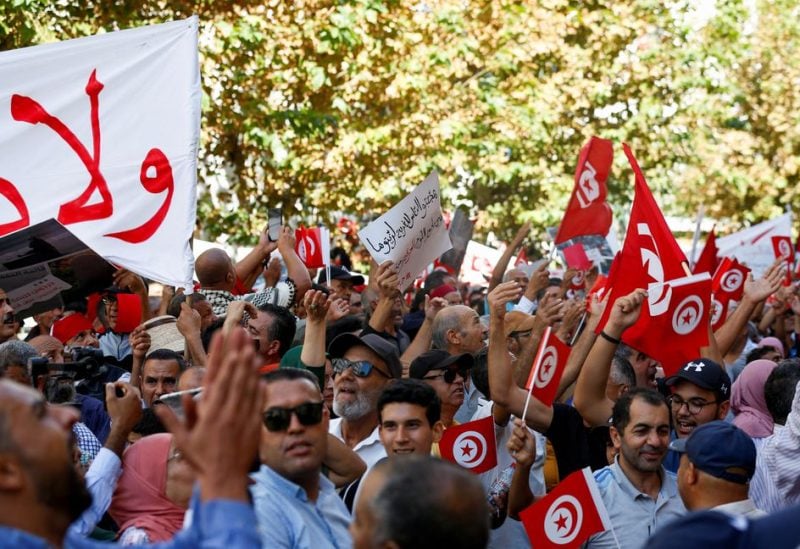 Supporters of Tunisia's Islamist opposition party Ennahda carry signs and flags during a protest against Tunisian President Kais Saied, in Tunis, Tunisia October 15, 2022. REUTERS/Zoubeir Souissi