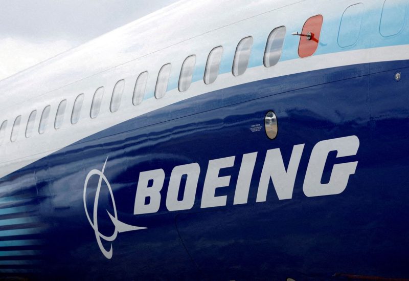 The Boeing logo is seen on the side of a Boeing 737 MAX at the Farnborough International Airshow, in Farnborough, Britain, July 20, 2022. REUTERS/Peter Cziborra/File Photo