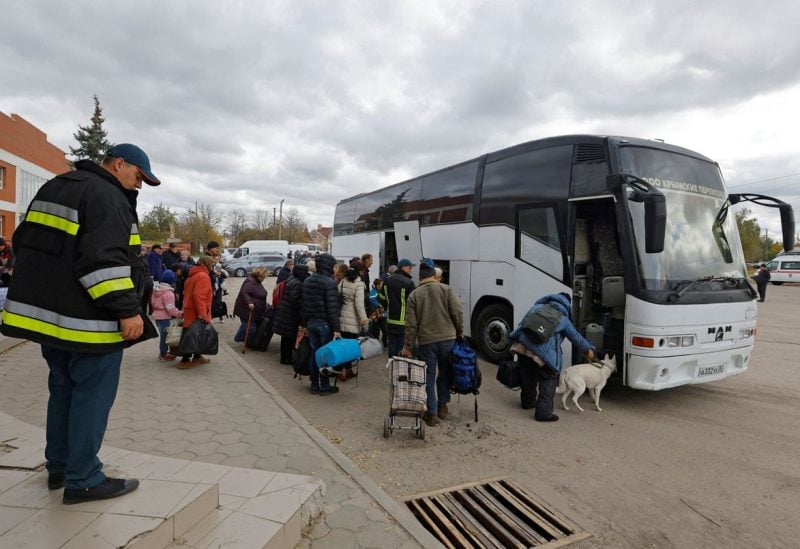 Civilians evacuated from the Russian-controlled city of Kherson board a bus heading to Crimea, in the town of Oleshky, Kherson region, Russian-controlled Ukraine October 22, 2022. REUTERS/Alexander Ermochenko