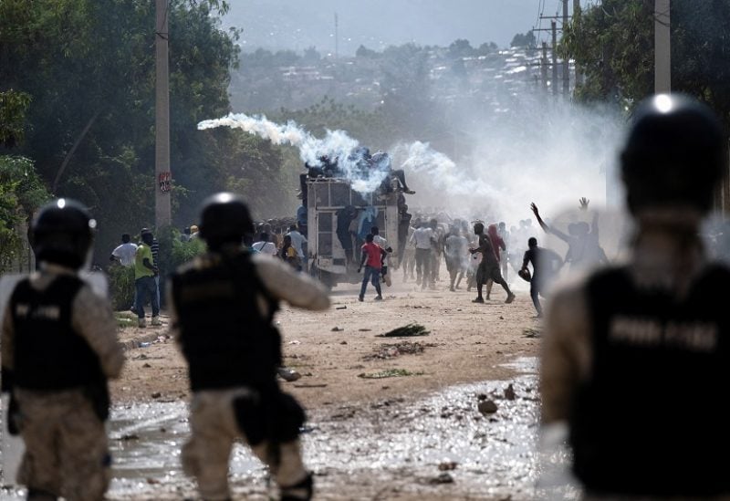 Haitian National police officers deploy tear gas during a protest demanding the resignation of Haiti's Prime Minister Ariel Henry after weeks of shortages in Port-au-Prince, Haiti, October 17, 2022. REUTERS/Ricardo Arduengo