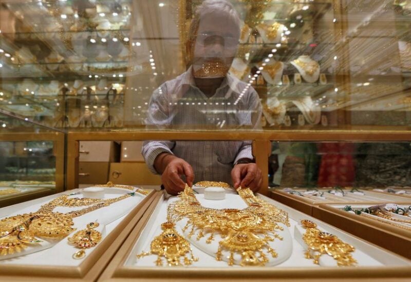 A salesman arranges a gold necklace in a display case inside a jewellery showroom on the occasion of Akshaya Tritiya, a major gold buying festival, in Kolkata, India, May 9, 2016. REUTERS