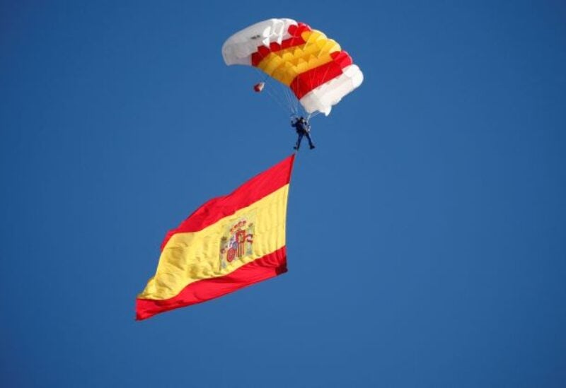A skydiver waving Spain's flag attends a military parade to mark Spain's National Day, in Madrid, Spain, October 12, 2022. REUTERS